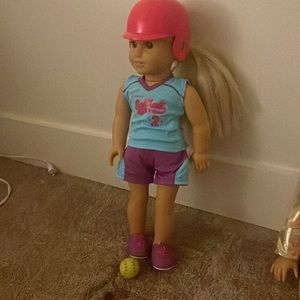 3 american girl dolls, softball helmet,softball crutches and a arm cast.